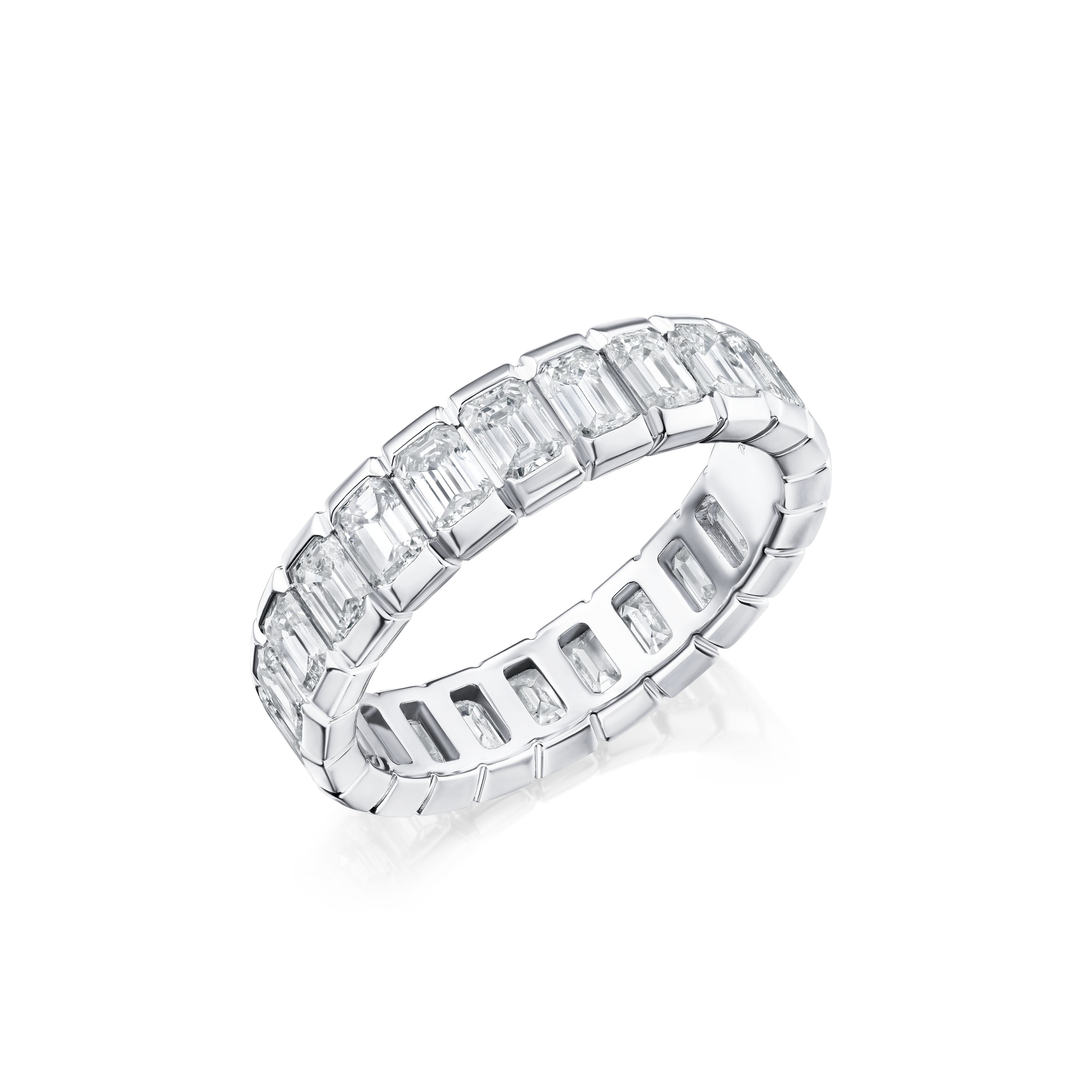 Diamond ring with emerald-cut stones on a white background