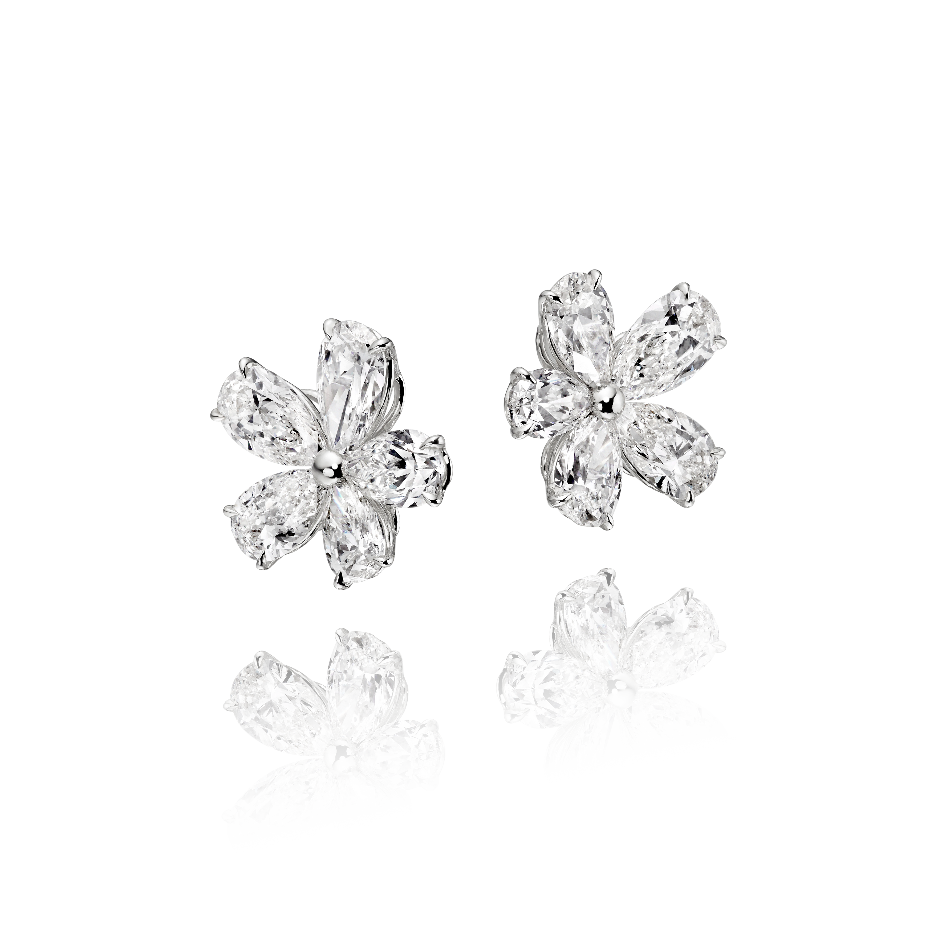 Four diamond flower earrings on a clear background