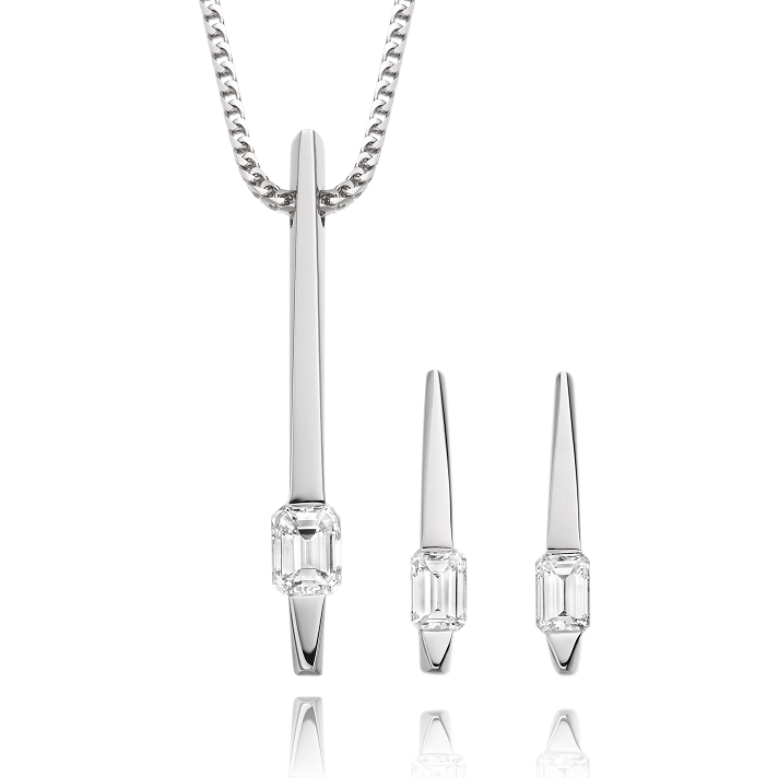 Silver jewelry set with pendant, bar earrings, and cylindrical earrings on a white background