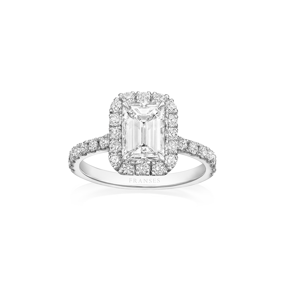 Diamond ring with emerald-cut center stone and halo on a white background
