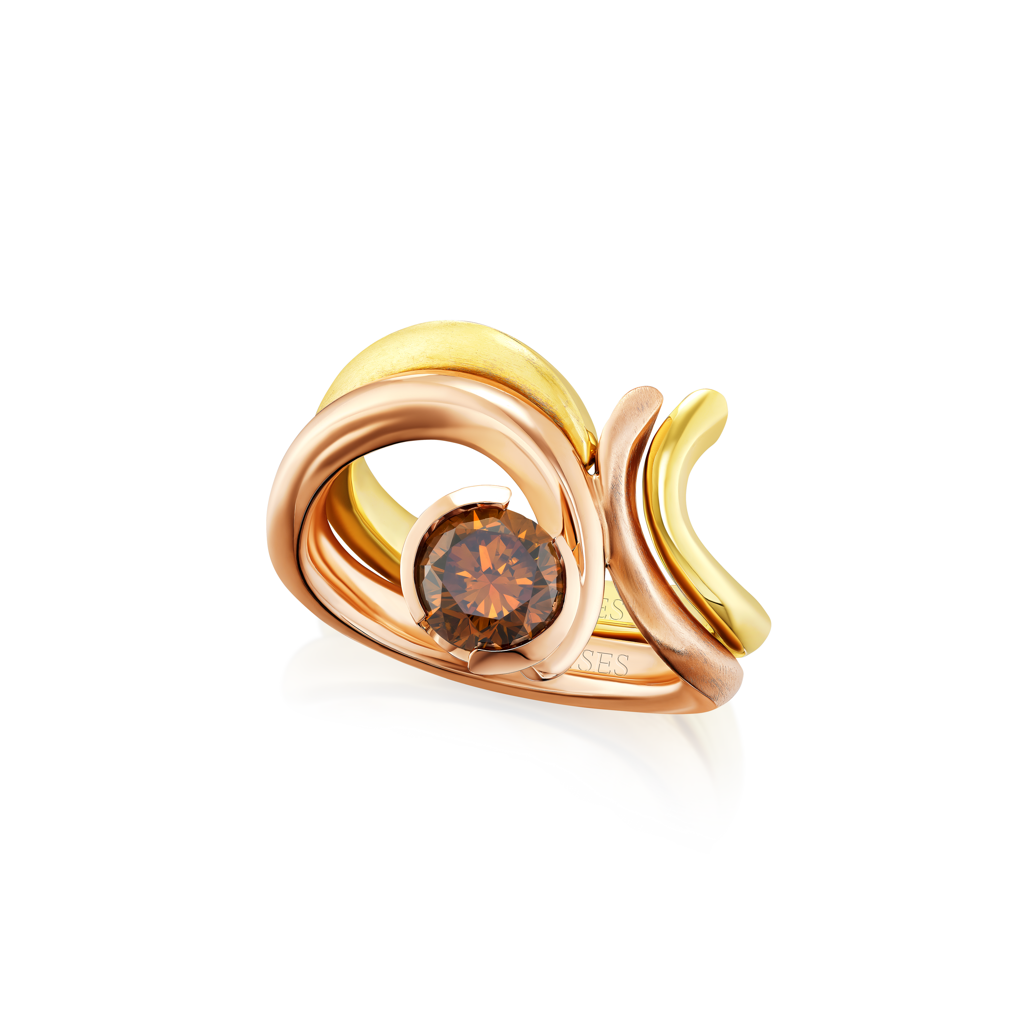 Gold and rose gold ring with a brown gemstone on a white background