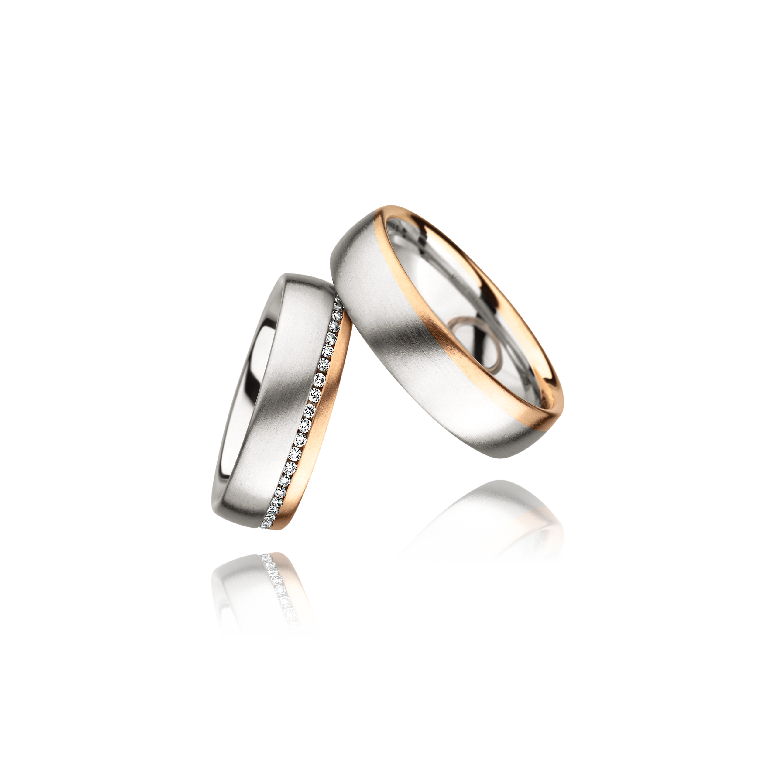 Two wedding rings, one silver and one rose gold, on a white background