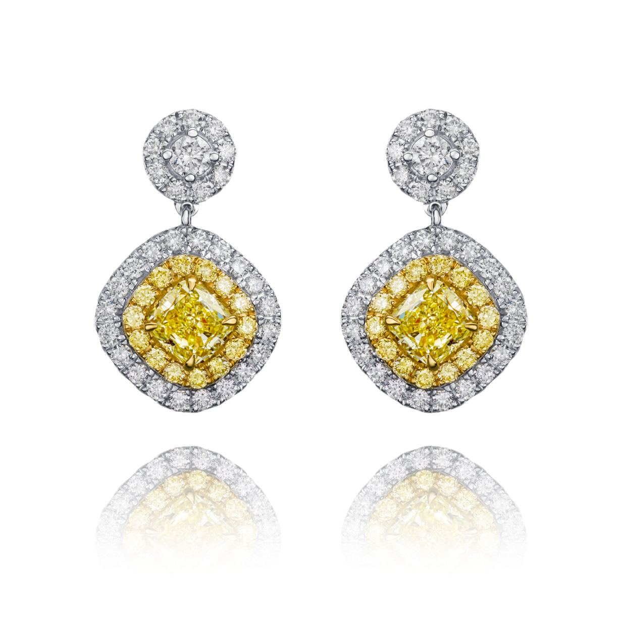 Pair of earrings with yellow gemstones and diamond accents on a white background