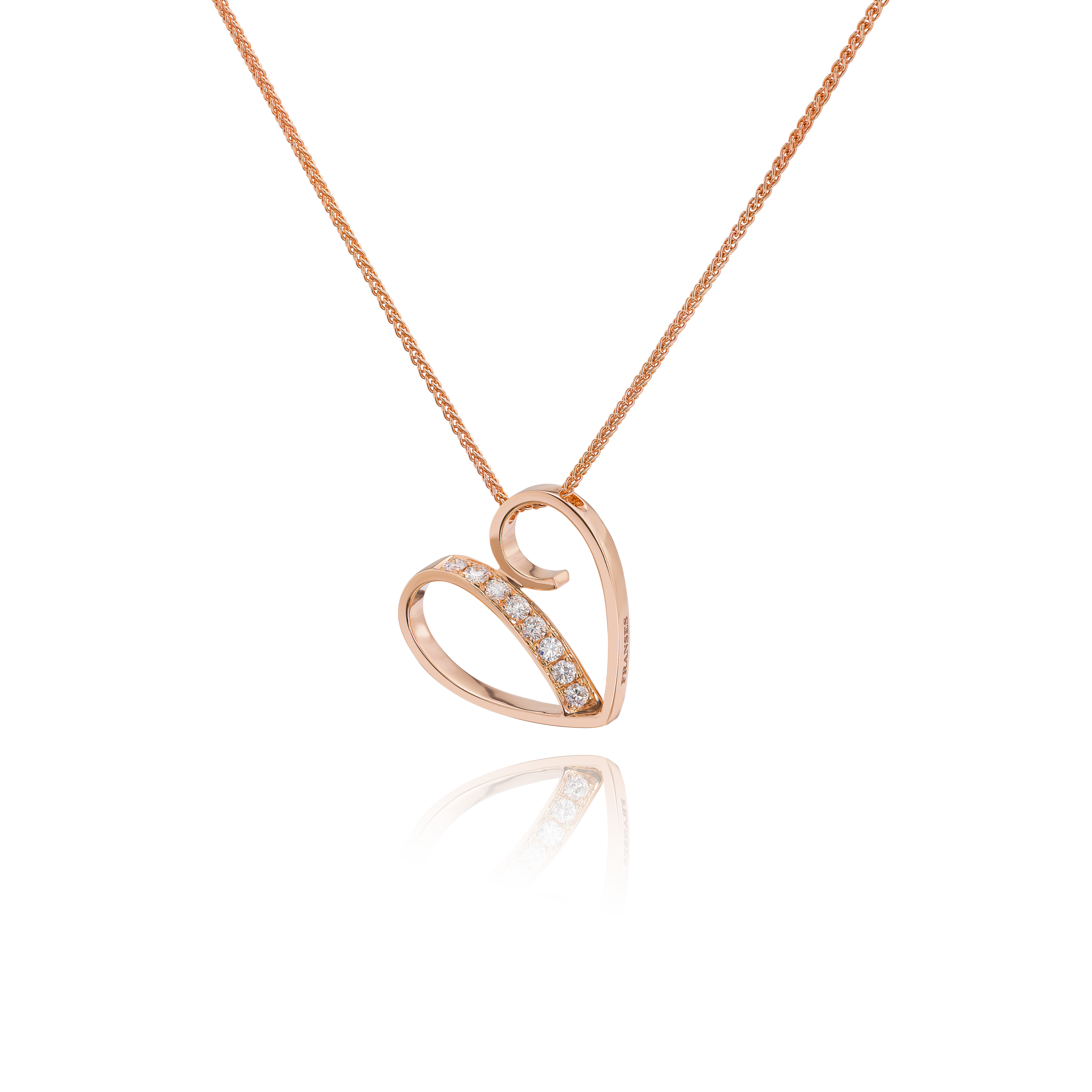 Rose gold necklace with a leaf-shaped pendant on a black background