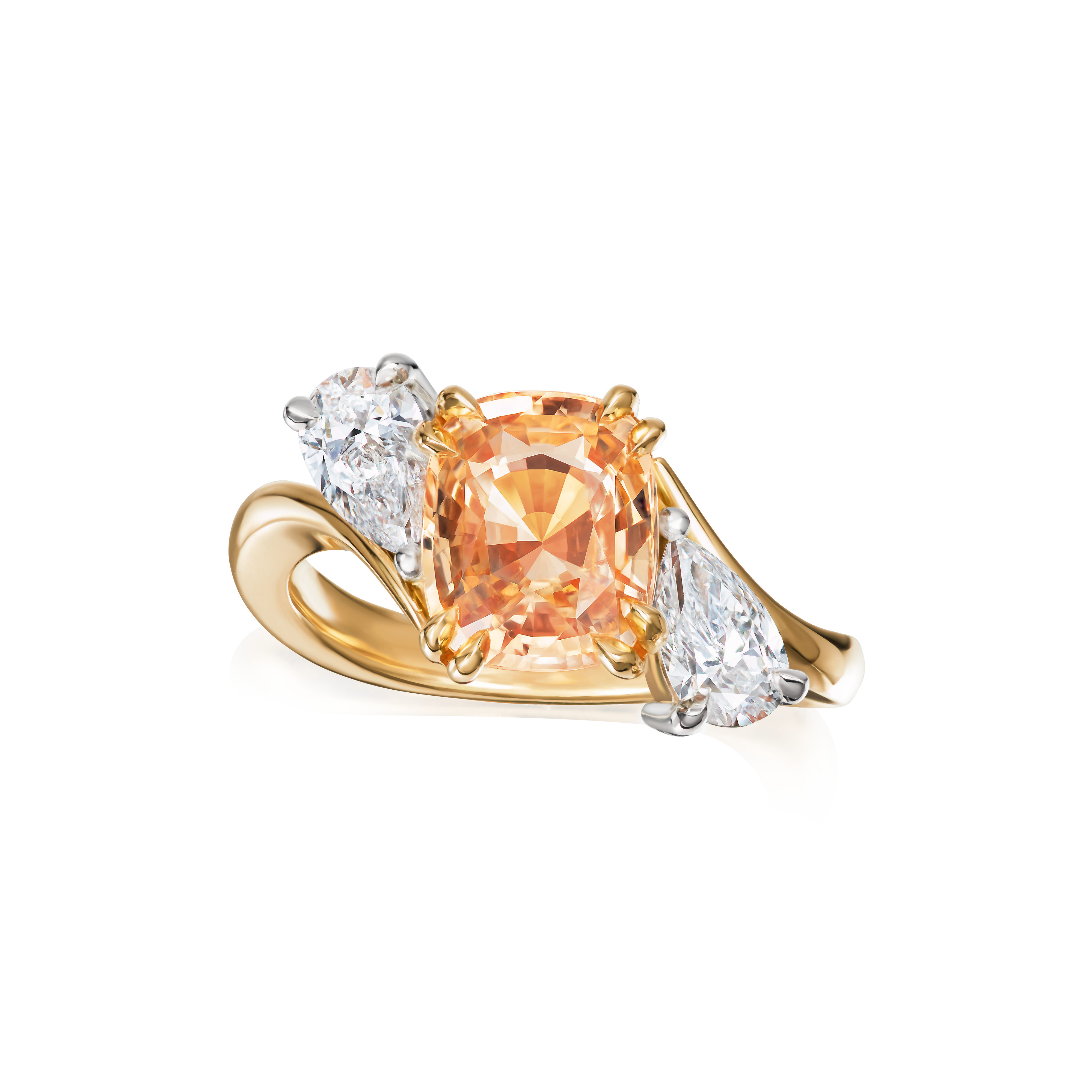 Gold ring with a peach-colored gemstone and two smaller clear stones on a white background