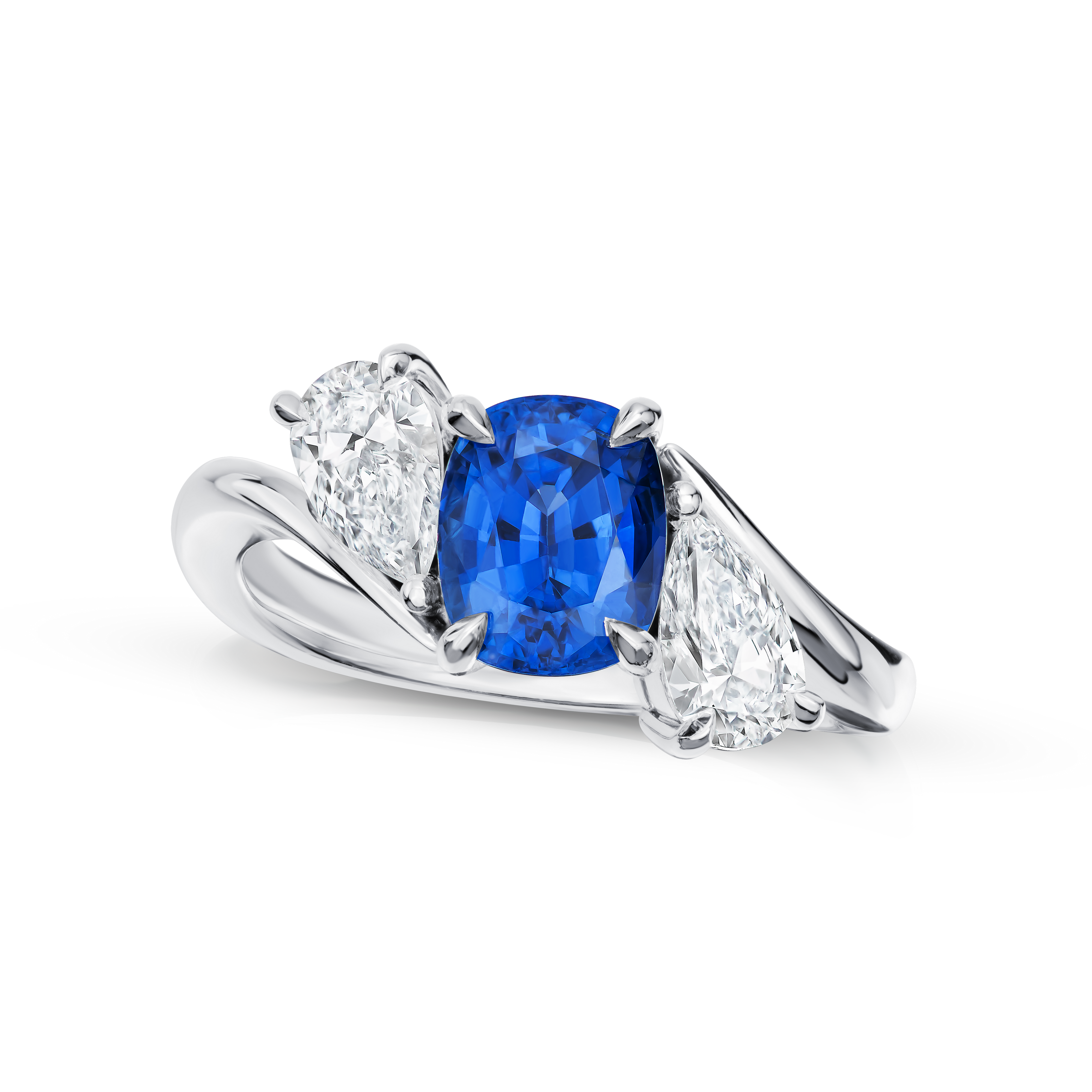 Ring with a blue gemstone and pear-shaped diamonds on a white background