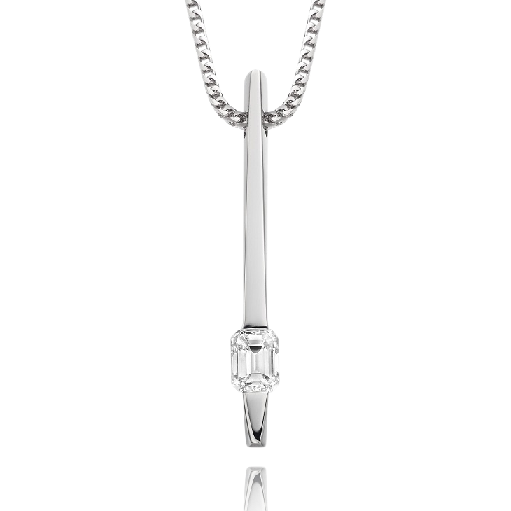 Silver pendant necklace with a clear gemstone on a white background