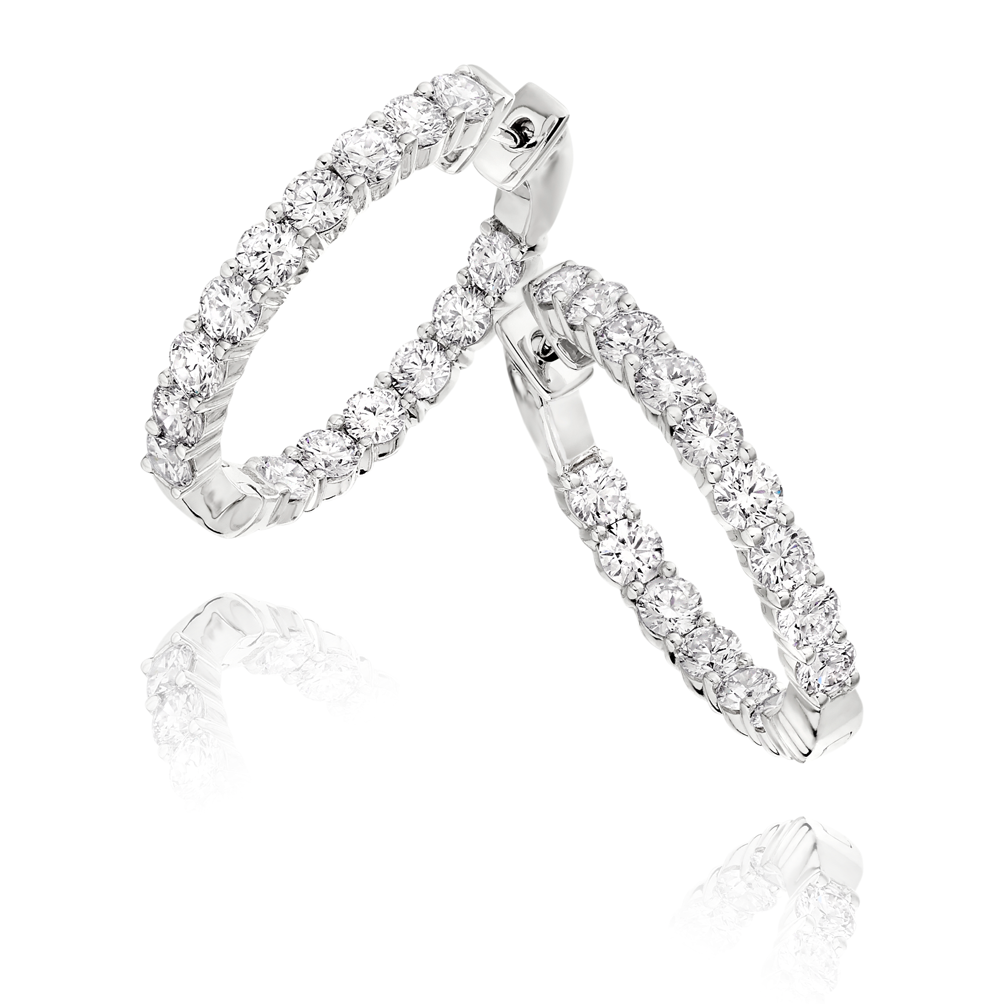 Pair of silver hoop earrings with clear gemstones on a white background