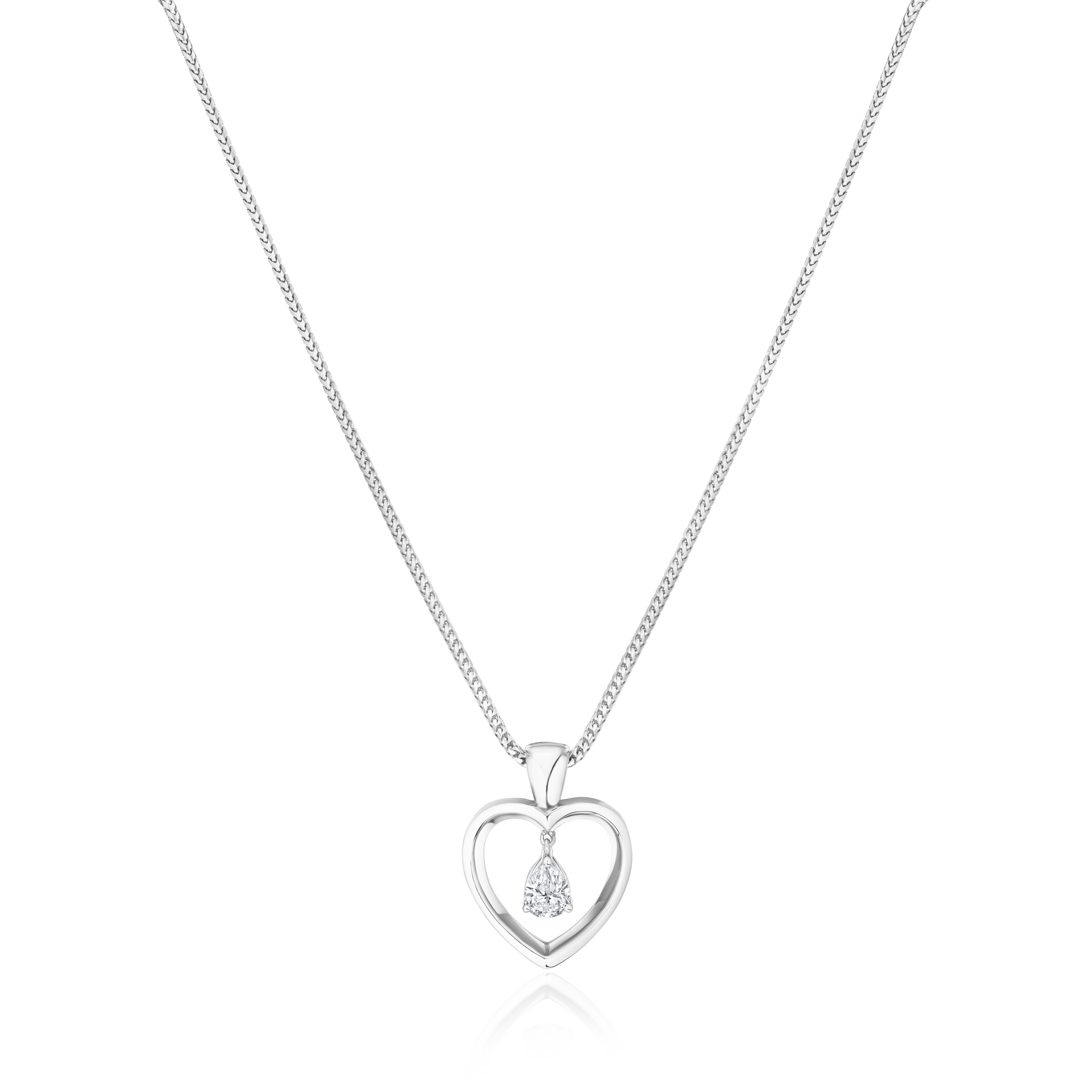 Heart-shaped diamond pendant on a white chain against a white background