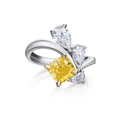 Diamond ring with a yellow center stone on a white background