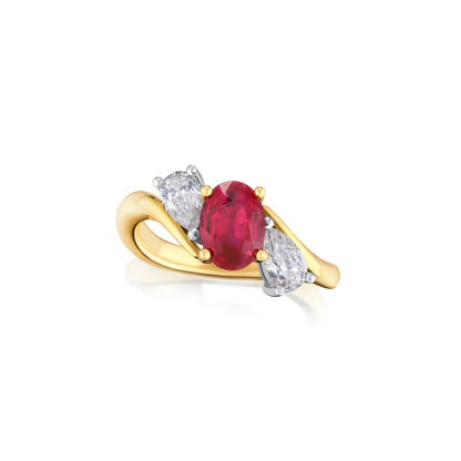 Gold ring with a ruby gemstone and two diamonds on a white background