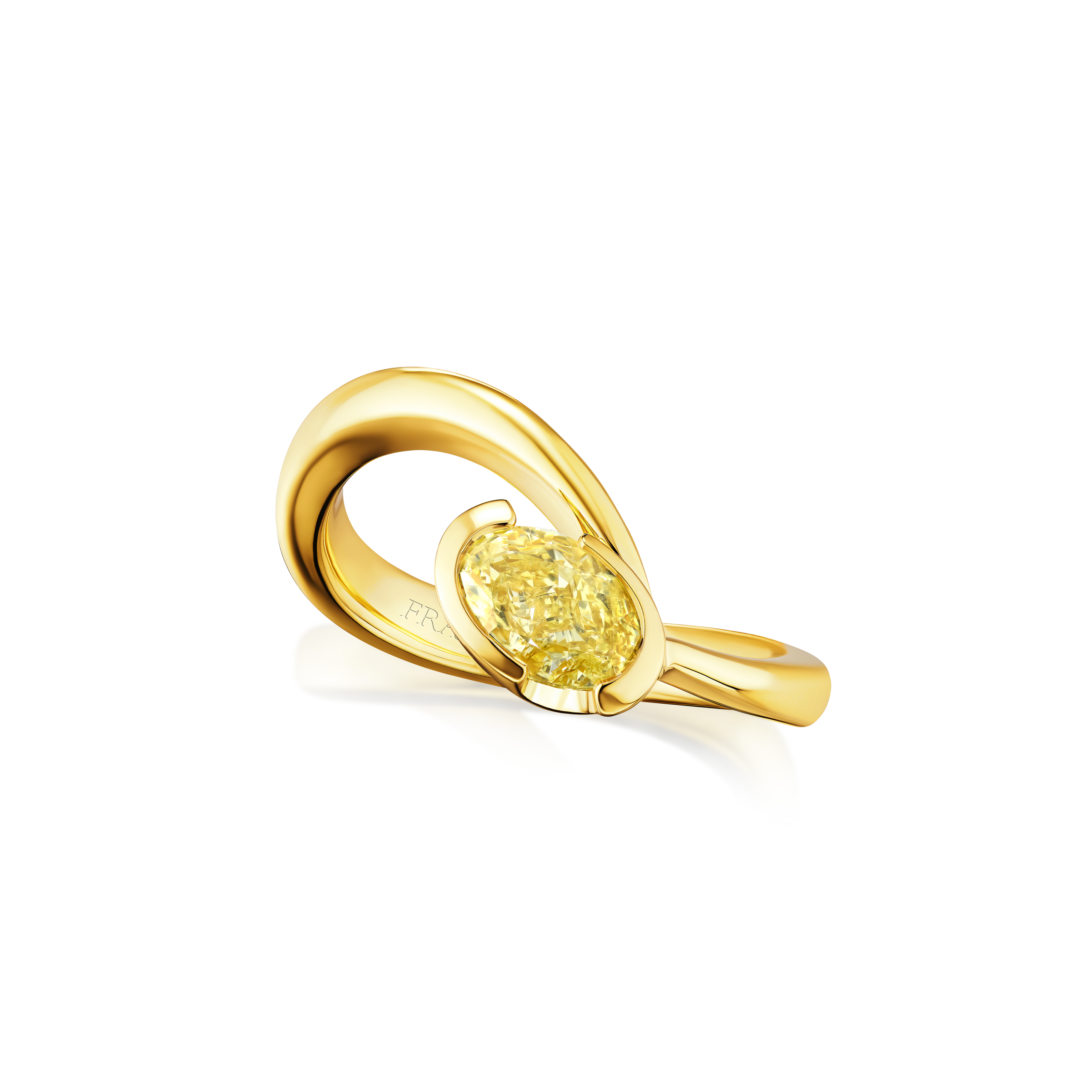 Gold ring with a yellow gemstone on a white background