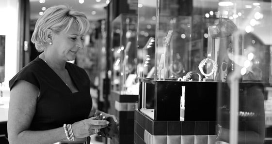 Woman in a jewelry store looking at jewelry displays